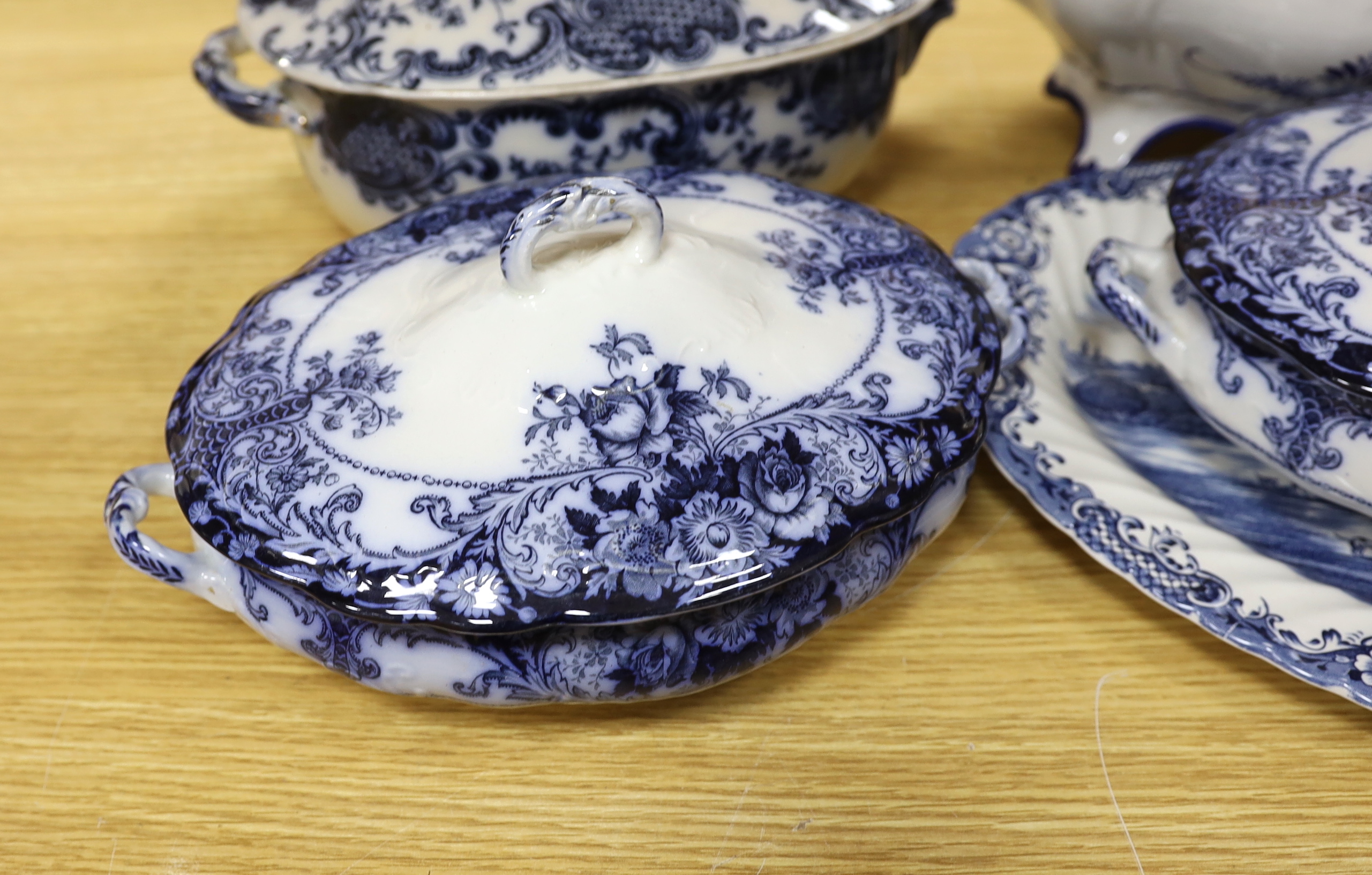 Two blue and white soup tureens and two vegetable tureens and a meat dish